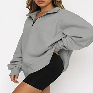 Detail view of women's grey half-zip fleece sweatshirt with casual loose fit design