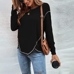 Elegant women's black long sleeve T-shirt with button details and irregular hem