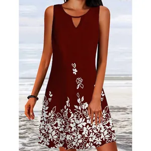 Detailed view of burgundy sleeveless summer dress with white floral print on a beach