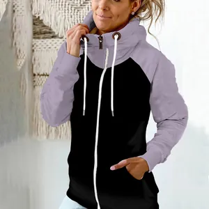 Detail view of a women's two-tone zip-up hoodie with high neck and drawstrings.