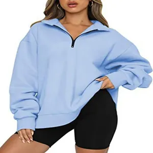 Detailed view of light blue half-zip oversized sweatshirt on model for autumn fashion