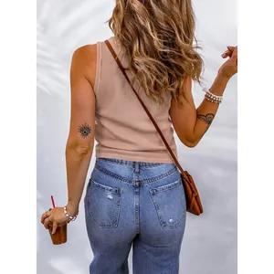 Detailed back view of a woman wearing a casual beige ribbed tank top with blue denim jeans