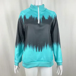 Detail view of a women's teal and black gradient print half-zip sweatshirt on a mannequin