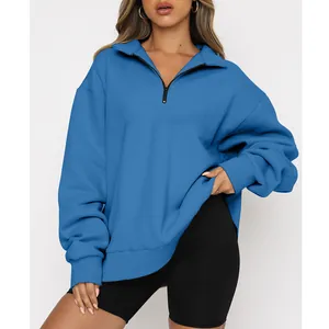 Detail shot of women's half-zip long sleeve oversized blue sweatshirt in soft fleece