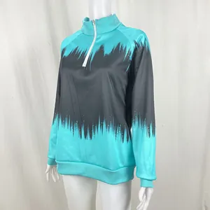Detailed view of turquoise and grey gradient print on long sleeve half-zip sweatshirt