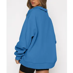 Detailed back view of a cozy women's oversized blue half-zip sweatshirt with fleece lining