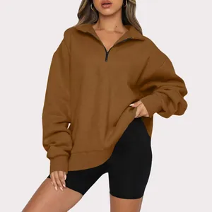 Macro detail view of a women's cozy brown half-zip fleece-lined sweatshirt for autumn