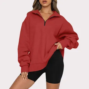 Close-up detail of women's red half-zip long sleeve fleece-lined sweatshirt casual top