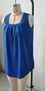 Close-up detail of a royal blue sleeveless tank top featuring a pleated square neckline