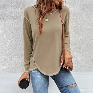 Close-up detail of a women's khaki long sleeve T-shirt featuring an irregular buttoned hem.