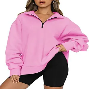 Women's casual pink half-zip sweatshirt featuring a stand-up collar and long sleeves.