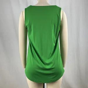 Detail showing the curved swallowtail hem of a vibrant green sleeveless tank top.