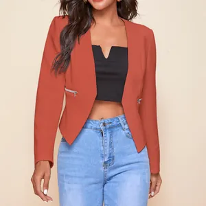 Close-up of rust orange women's blazer featuring stylish zipper pockets and open front design.