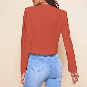 Back view of a chic burnt orange cropped blazer with structured shoulders for women.
