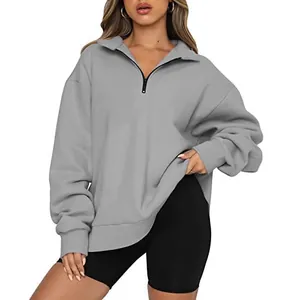 Stylish women's grey oversized half-zip long sleeve fleece sweatshirt for casual wear.