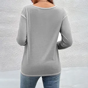 Back view detail of a casual grey long-sleeve T-shirt with white stitching on the hem.