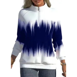 Close-up of women's half-zip sweatshirt with a vibrant blue and white gradient pattern.