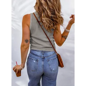 Detailed back view of a grey waffle-knit sleeveless tank top paired with casual denim jeans.