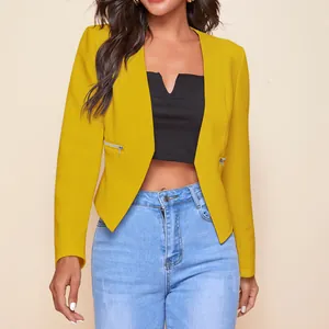 Detail view of mustard yellow cropped blazer with decorative zipper pockets.