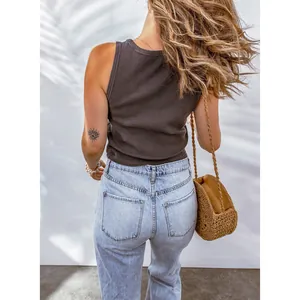 Back view of a brown waffle knit tank top paired with denim jeans and woven bag.