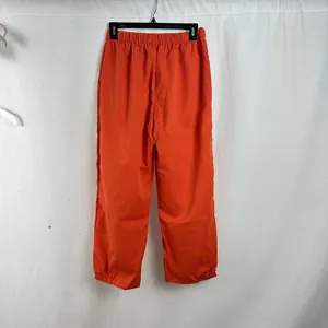 Back view detail of bright orange loose casual jogger pants for women