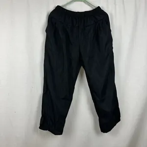 Back view of black women's loose casual pants with elastic waistband for summer wear.