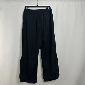 Detail view of black women's loose casual pants hanging on a black hanger