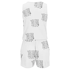 Close-up detail of the elegant cursive script print on a white sleeveless summer romper