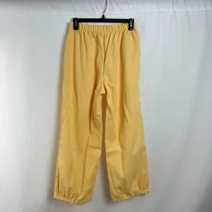 Detailed back view of women's yellow loose casual pants with elastic waist and cuffs