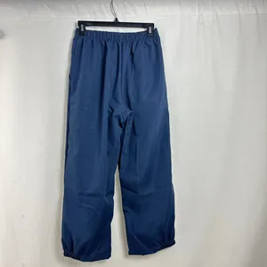 Back view of women's loose casual navy blue joggers pants with elastic waist and hem.