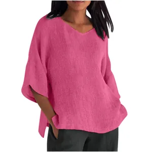 Detailed view of women's loose V-neck pink top with elegant mid-sleeves and soft texture