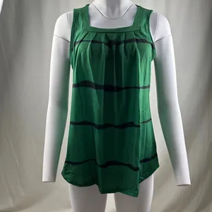 Detailed view of the pleated square neckline and dark stripes on a green tank top.