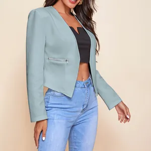 Stylish cropped light blue blazer with zipper pockets over black crop top and jeans