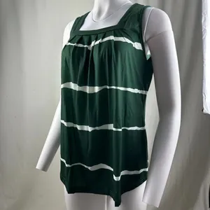 Detailed view of green and white striped tank top with square neck and pleats