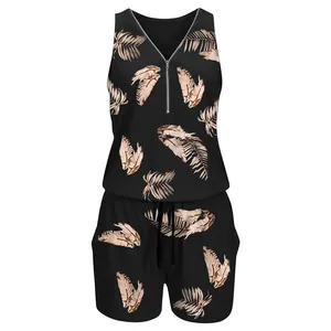 Close-up of sleeveless black romper with tropical leaf print and zipper V-neck detail.