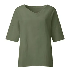 Detailed view of women's loose V-neck blouse in olive green with textured fabric