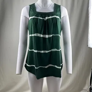 Close-up detail of a dark green sleeveless top featuring white stripes and a square neckline