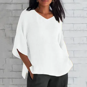 Detail showing the loose half sleeves and texture of this white V-neck linen top.