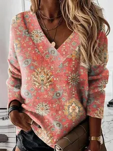 Detailed view of the vintage floral print on a long-sleeve V-neck sweatshirt top