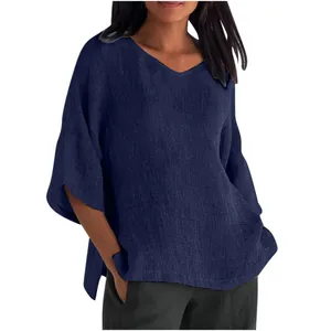 Detail view showing the linen texture and loose fit of this elegant navy blue V-neck top.