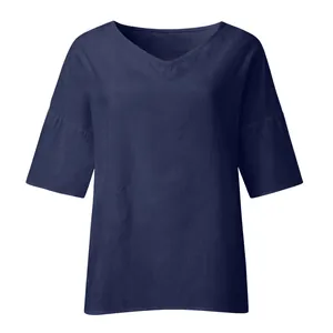 Detailed view of an elegant navy blue V-neck blouse featuring breathable textured summer fabric