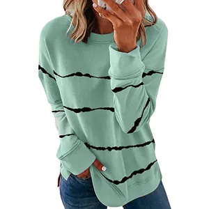 Vue détaillée d'un sweat-shirt ample de couleur vert menthe à rayures noires et col rond.