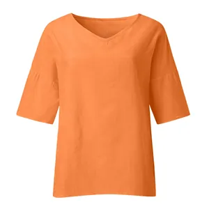 Close-up of bright orange V-neck blouse with loose mid-length sleeves and linen texture