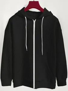 Detail of a black women's jacquard zip-up hoodie with white drawstrings and texture