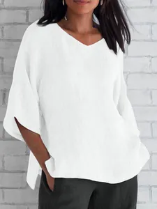 Elegant white loose V-neck linen blouse with short batwing sleeves for summer wear.
