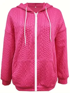 Detailed view of magenta pink cable-knit hoodie with white zipper and drawstrings.