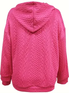 Back view of hot pink cable knit hoodie jacket showing intricate textured jacquard pattern