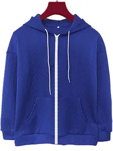 Detail view of blue jacquard zipper hoodie showing texture and front pocket design