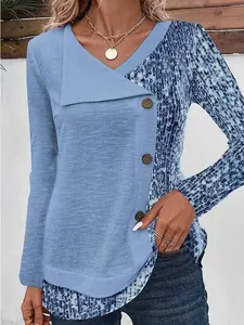 Detail view of a blue ribbed long sleeve top with animal print and button V-neck.