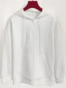 Detailed close-up of white cable-knit jacquard zip-up hoodie with drawstrings.
